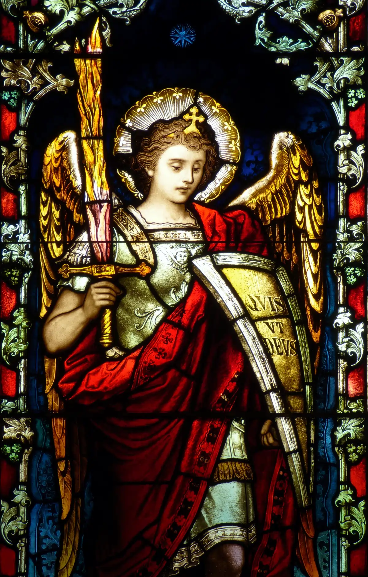 St. Michael the Archangel St. Michael in stained glass window by Franz Mayer & Co. Quis ut Deus? ('Who is like God?') is on his shield.